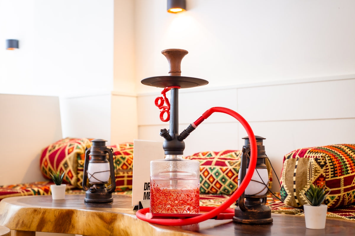 red and black hookah on brown wooden table