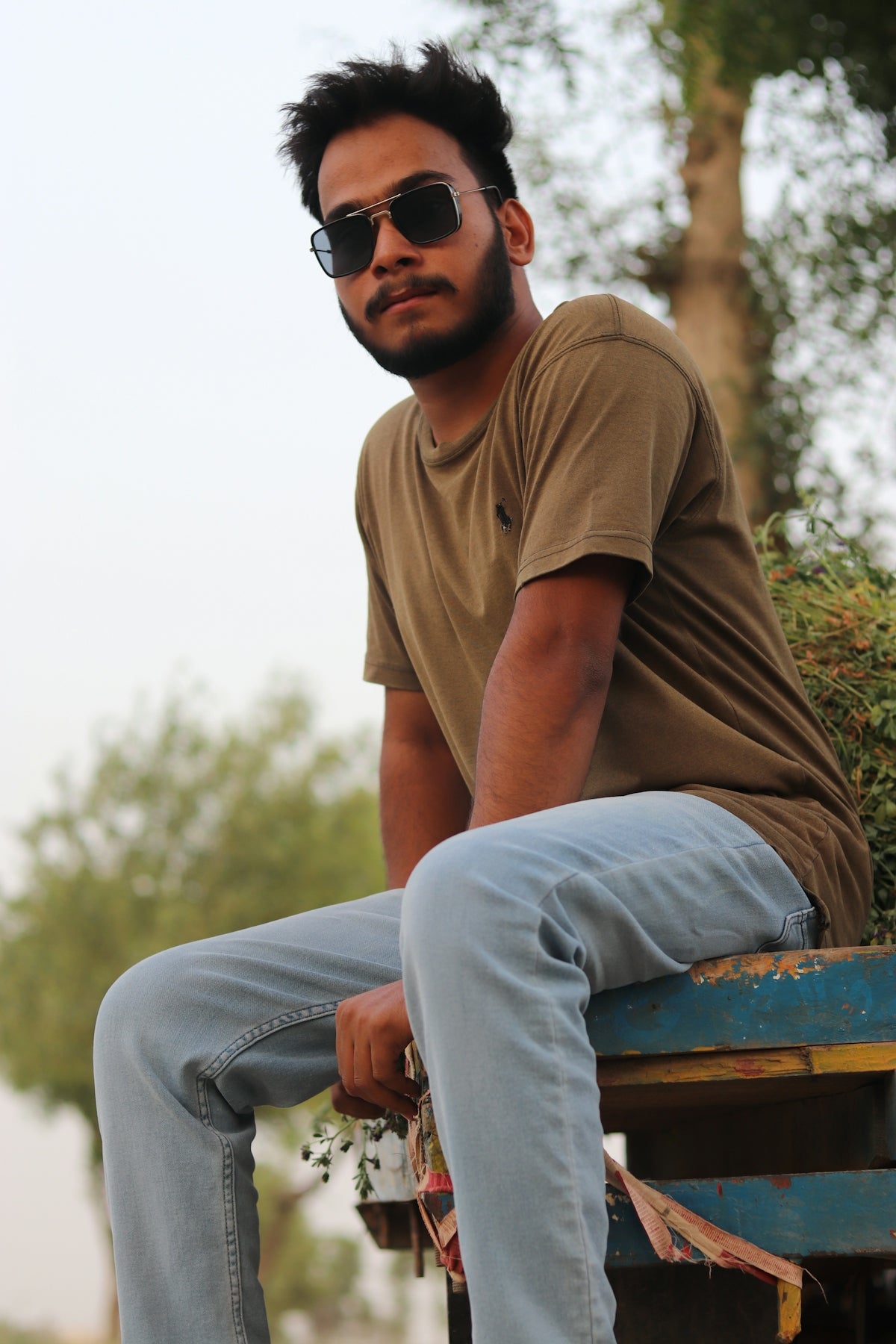 a man sitting on a blue bench