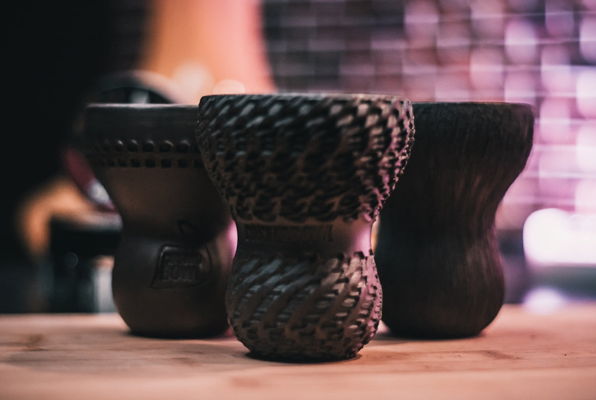 a couple of vases sitting on top of a wooden table