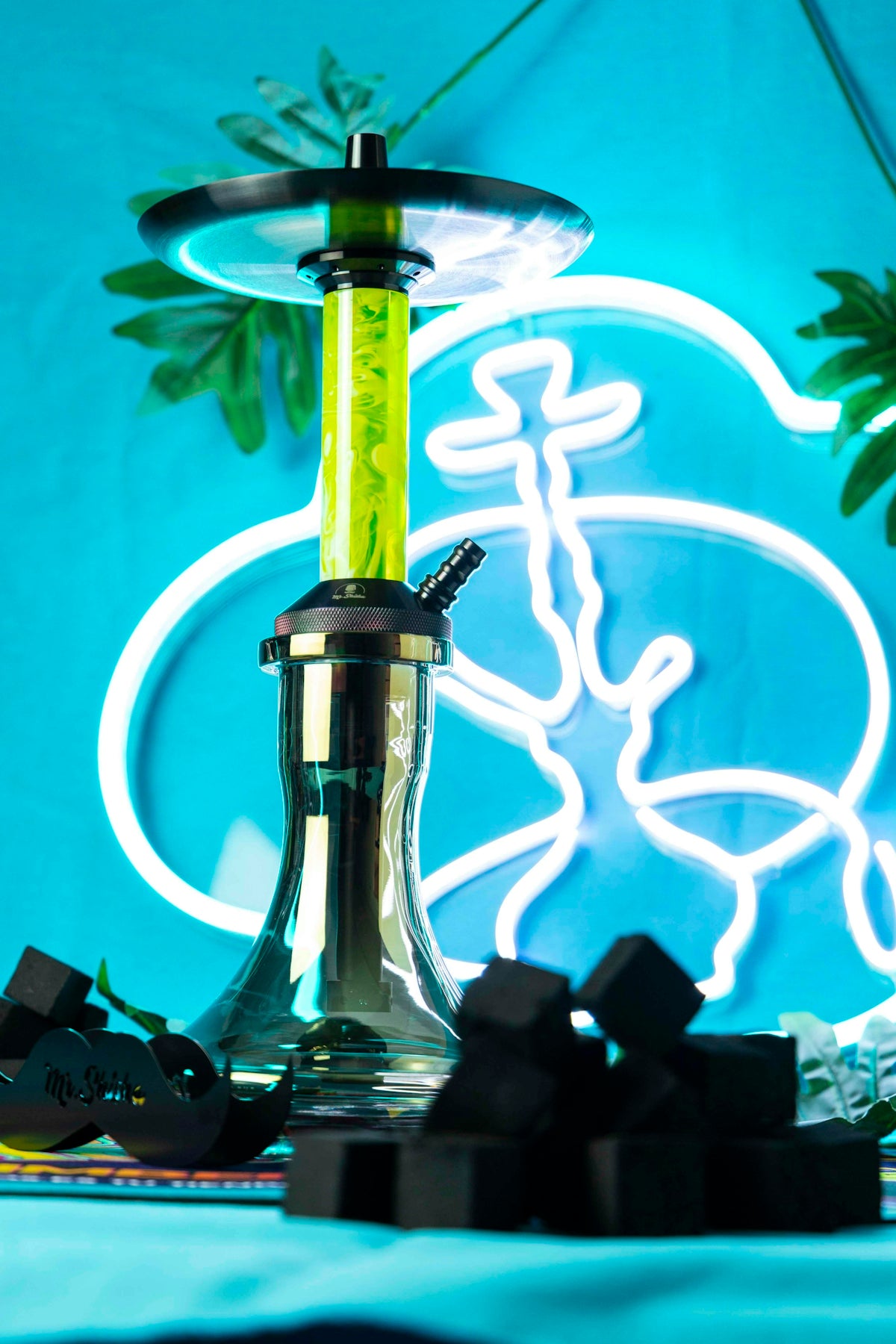 a blender with a green handle sitting on top of a table