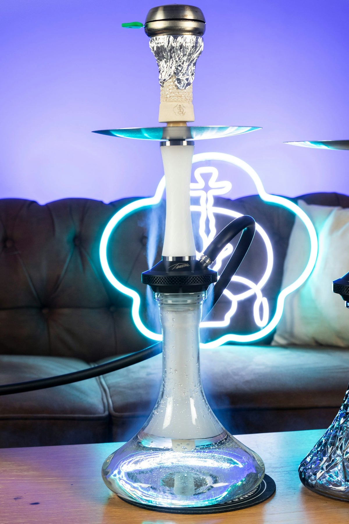 a glass hookah sitting on top of a wooden table