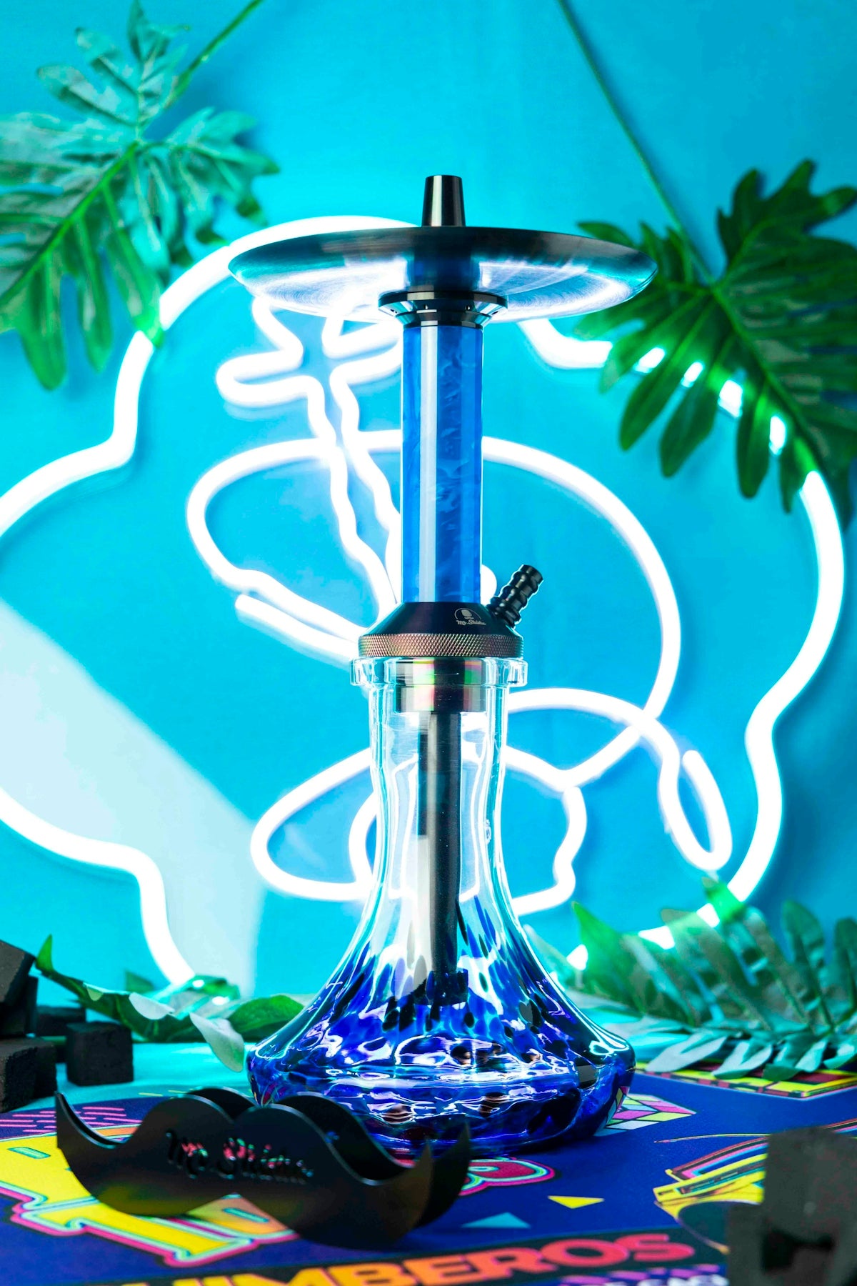 a blue glass hookah sitting on top of a table