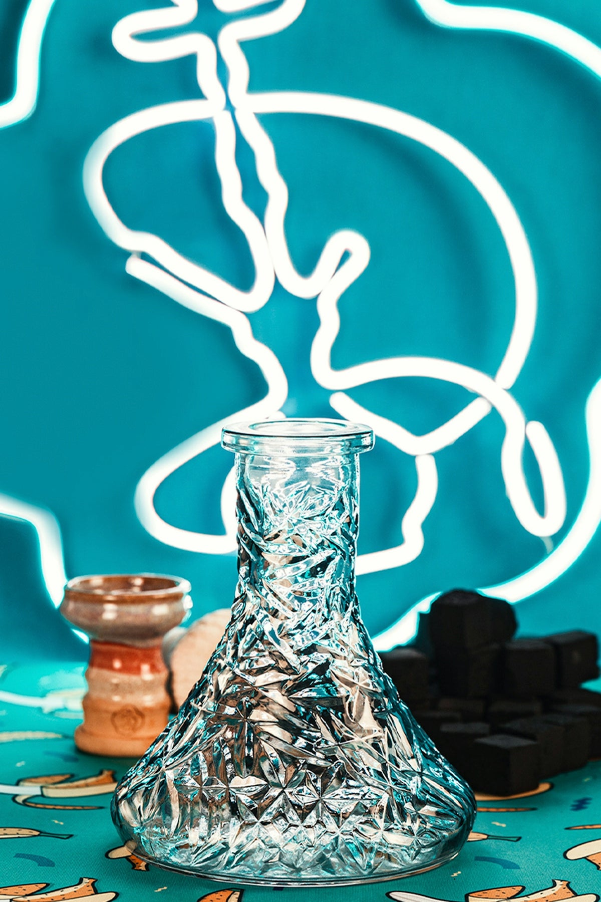A shisha base with accessories on colorful background