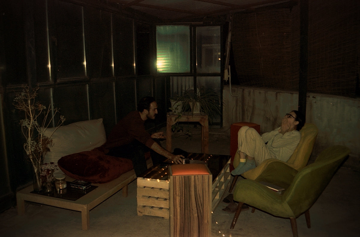 Friends relax in an outdoor lounge area.