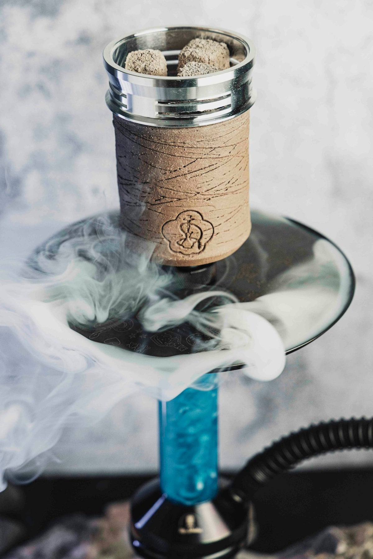 Hookah with smoke rising from coals